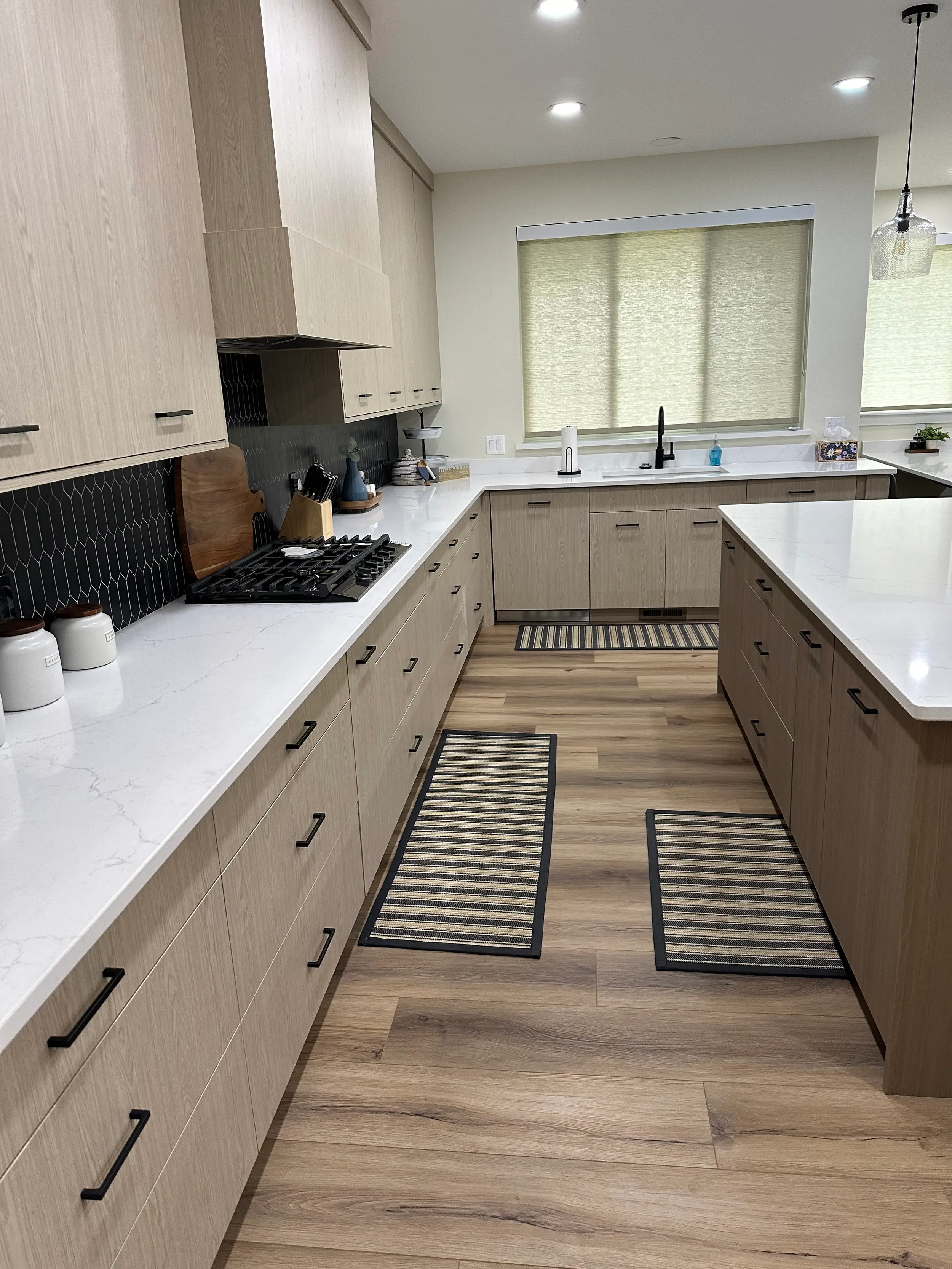 Custom pull-out drawer and pot storage system, built into cabinetry by hand for functional, space-efficient kitchen organization.